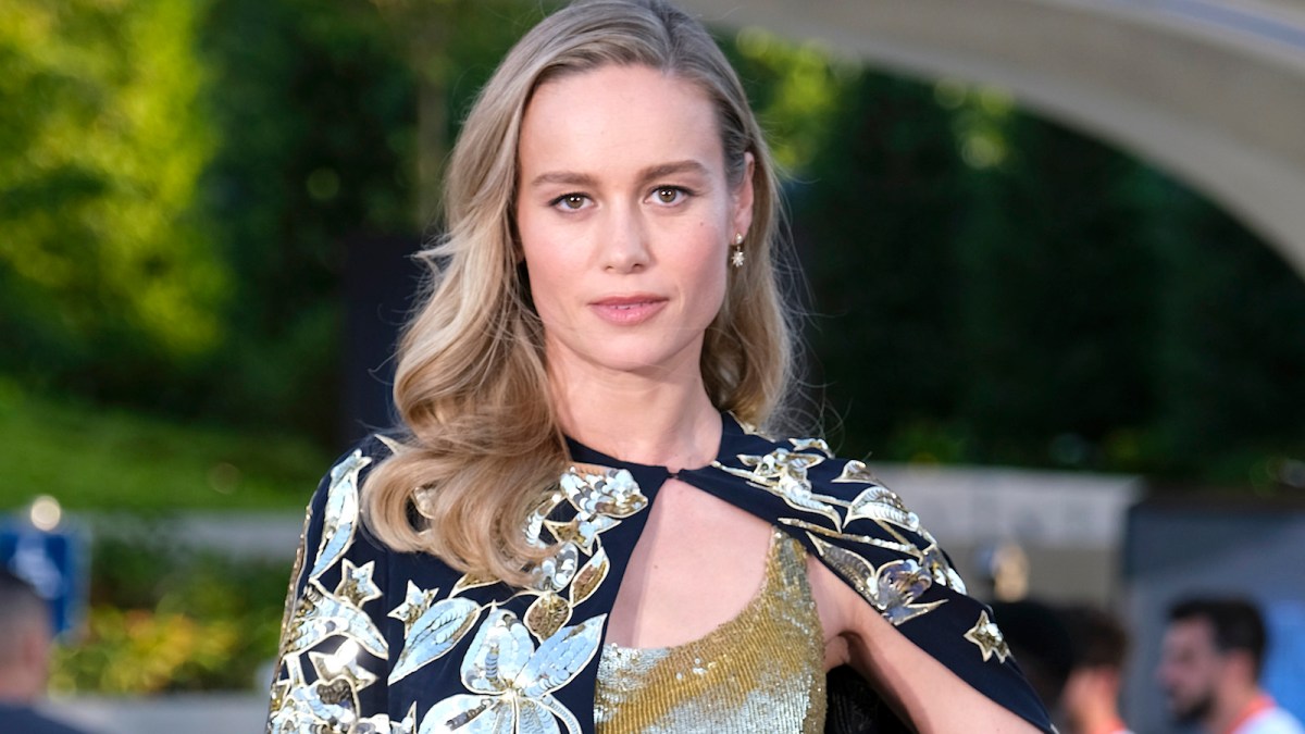 Brie Larson in a gold and black dress