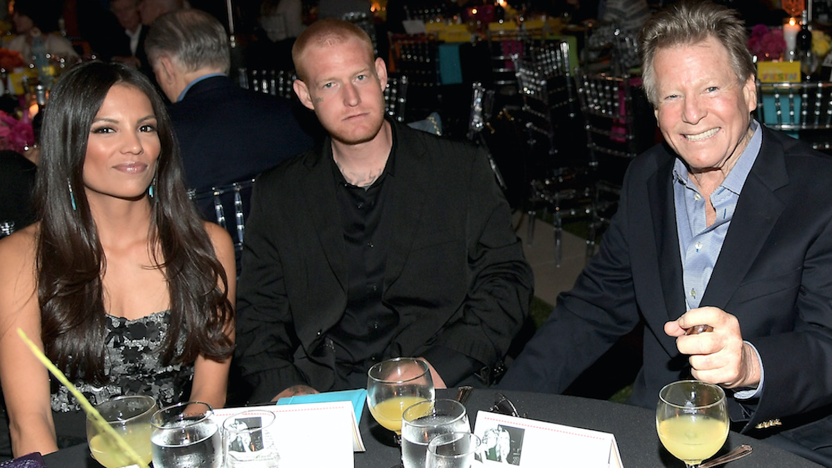 Redmond is sitting with his mother and father at an awards dinner. 