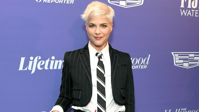 Selma Blair in a black and white suit and short blonde hair