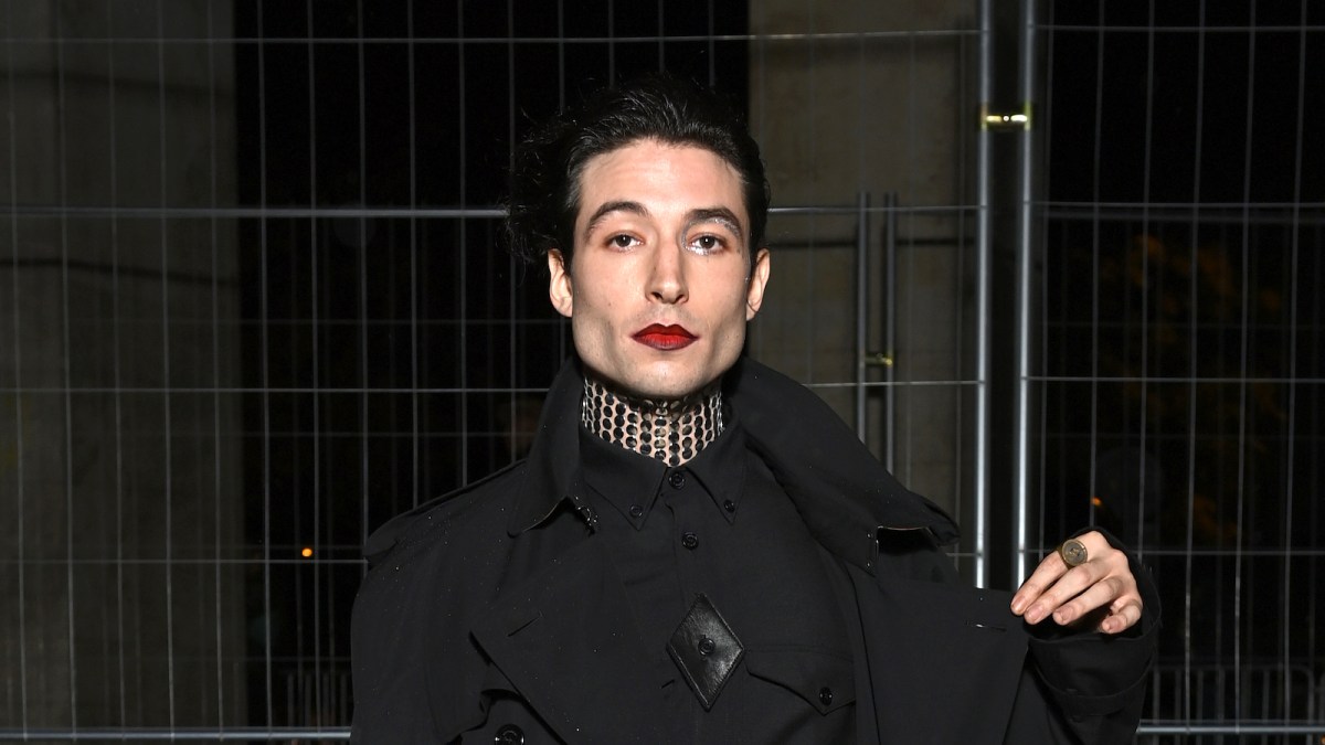 Ezra Miller attends Burberry closing party for Anne Imhof's Exhibition 'Natures Mortes'at Palais de Tokyo on October 18, 2021 in Paris, France wearing all black and red lipstick.