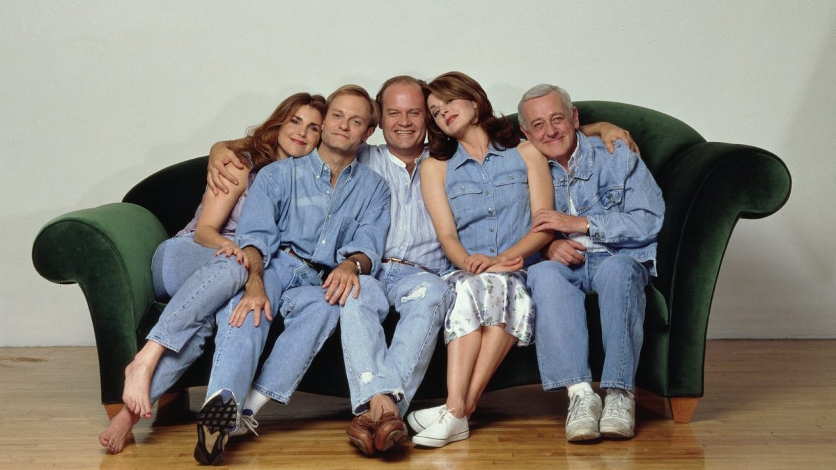The cast of 'Frasier' pose in matching denim outfits on a sofa for a promo photoshoot