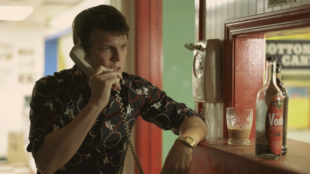 Jake Lacy on the phone in Friend of the Family