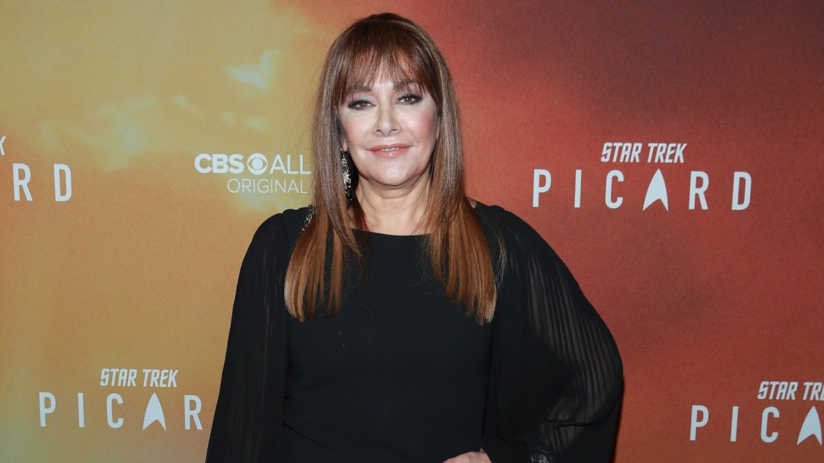 Marina Sirtis strikes a pose at a red carpet event.