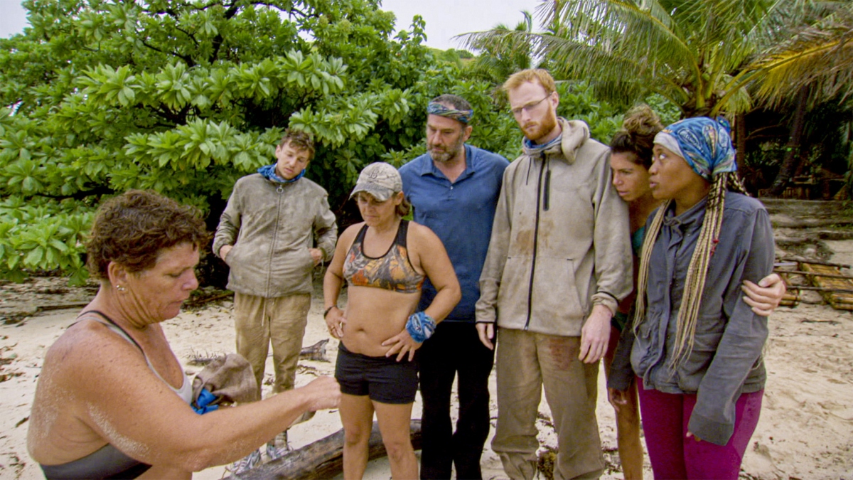 A group on Survivor is talking to one another.