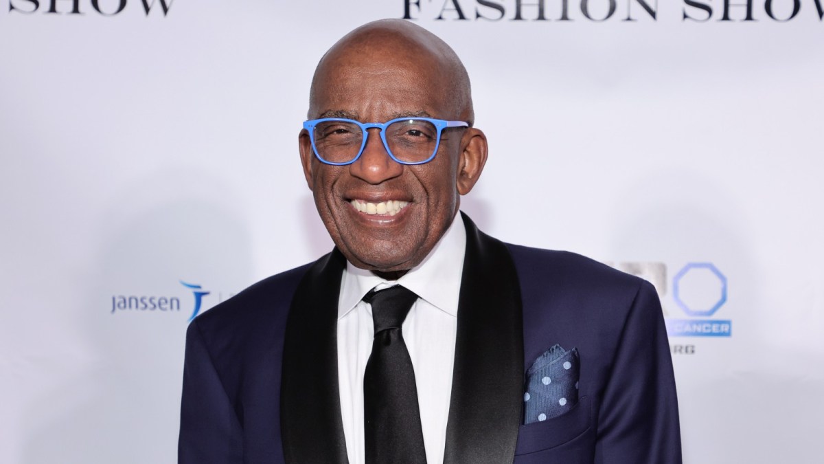 Al Roker strikes a pose at a red carpet event.