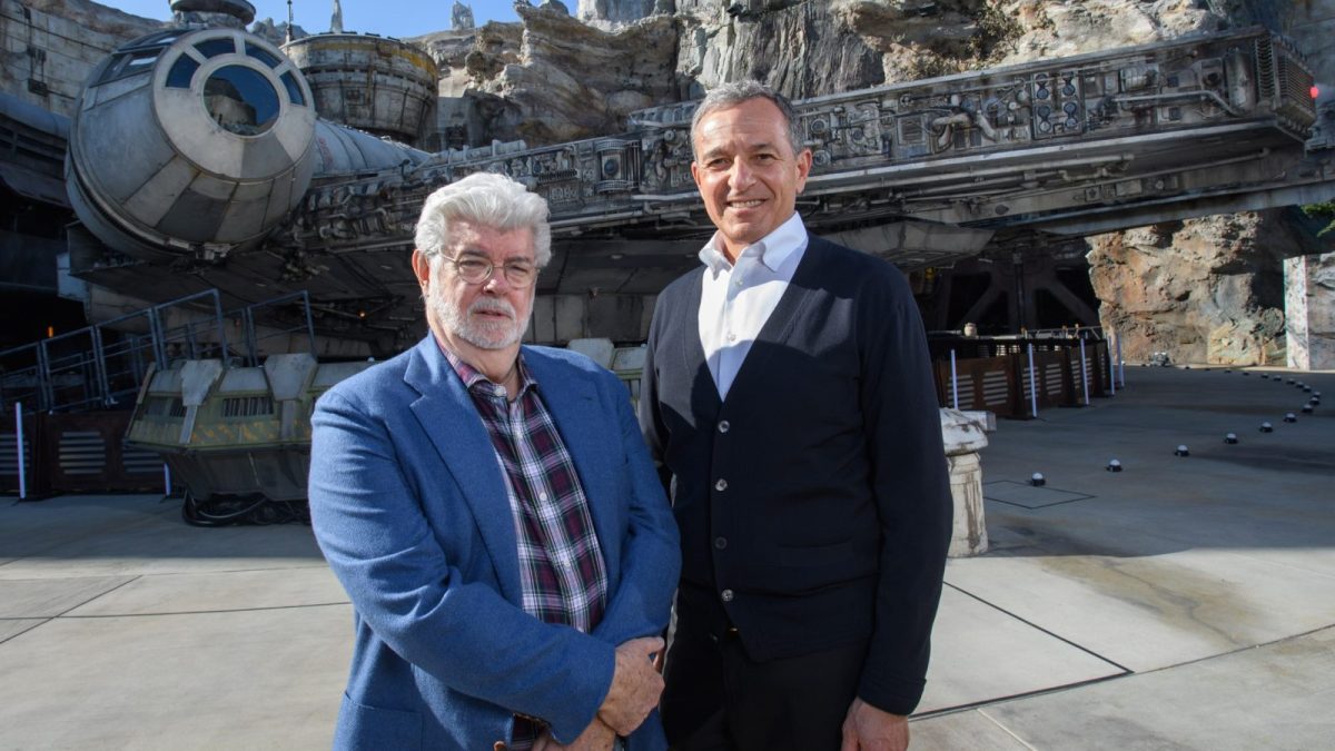 In this handout photo provided by Disneyland Resort, Walt Disney Company Chairman and CEO Bob Iger (R), and Star Wars creator George Lucas stand in front of the Millennium Falcon at Star Wars: Galaxy's Edge at Disneyland Park in Anaheim, California, May 29, 2019. (Photo by Richard Harbaugh/ Disneyland Resort via Getty Images)