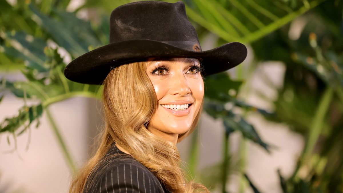 Jennifer Lopez in a black and white striped suit and black cowboy hat