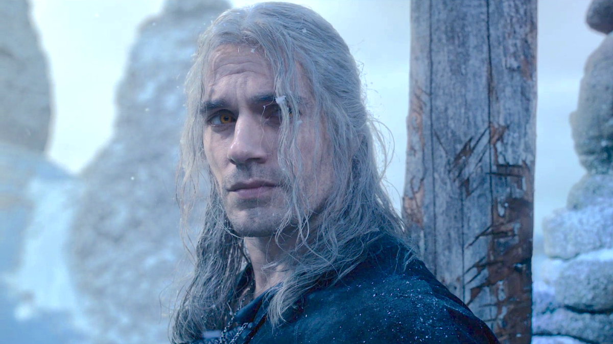Geralt of Rivia (Henry Cavill) sporting his signature white hair surrounded by mountains of white snow