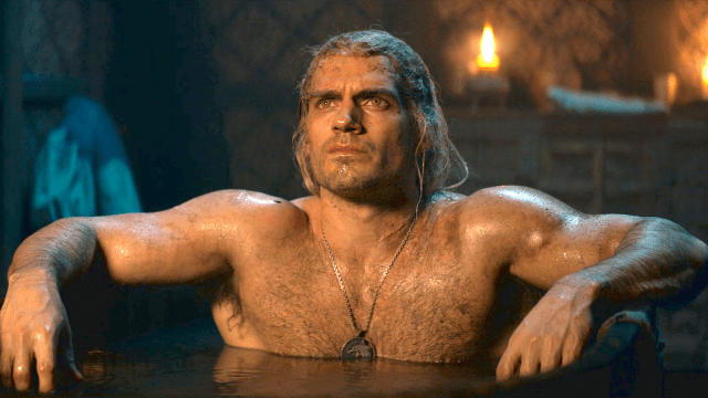 Geralt of Rivia (Henry Cavill) topless in a bathtub wearing his Witcher pendant around his neck