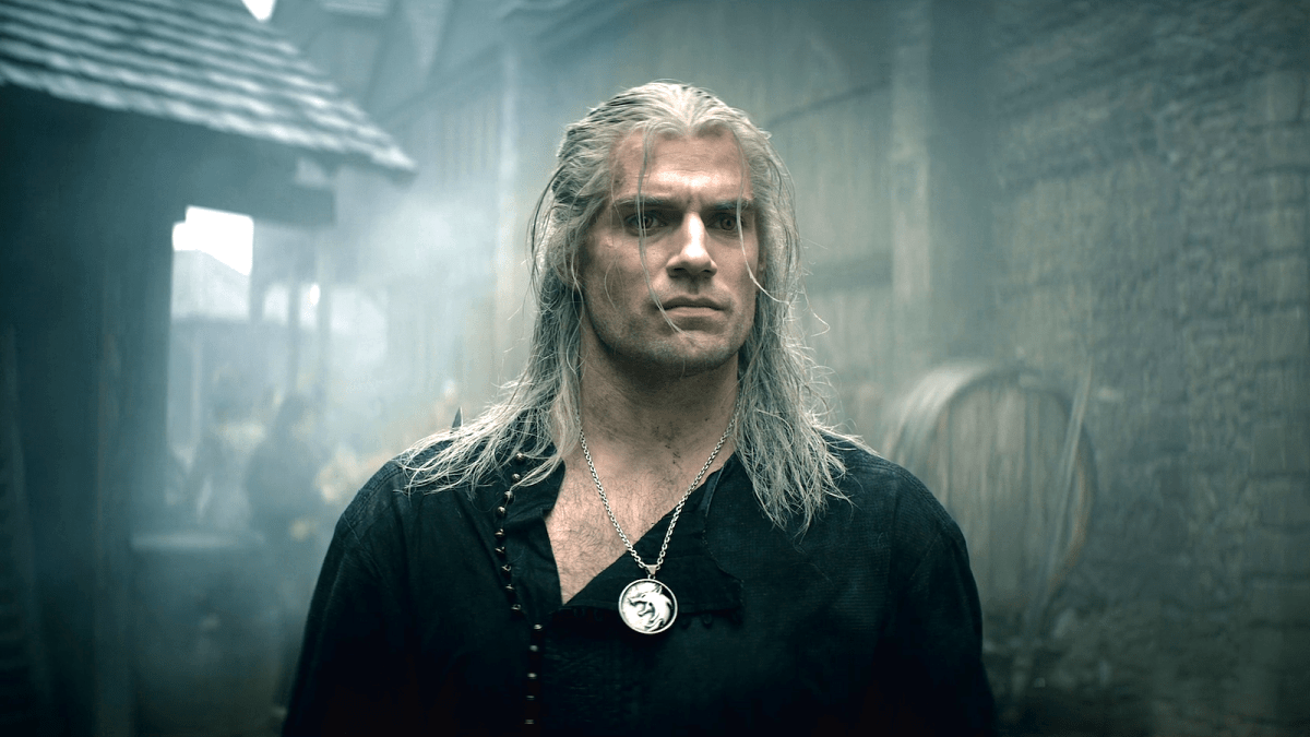 Geralt of Rivia (Henry Cavill) in a black shirt and white hair