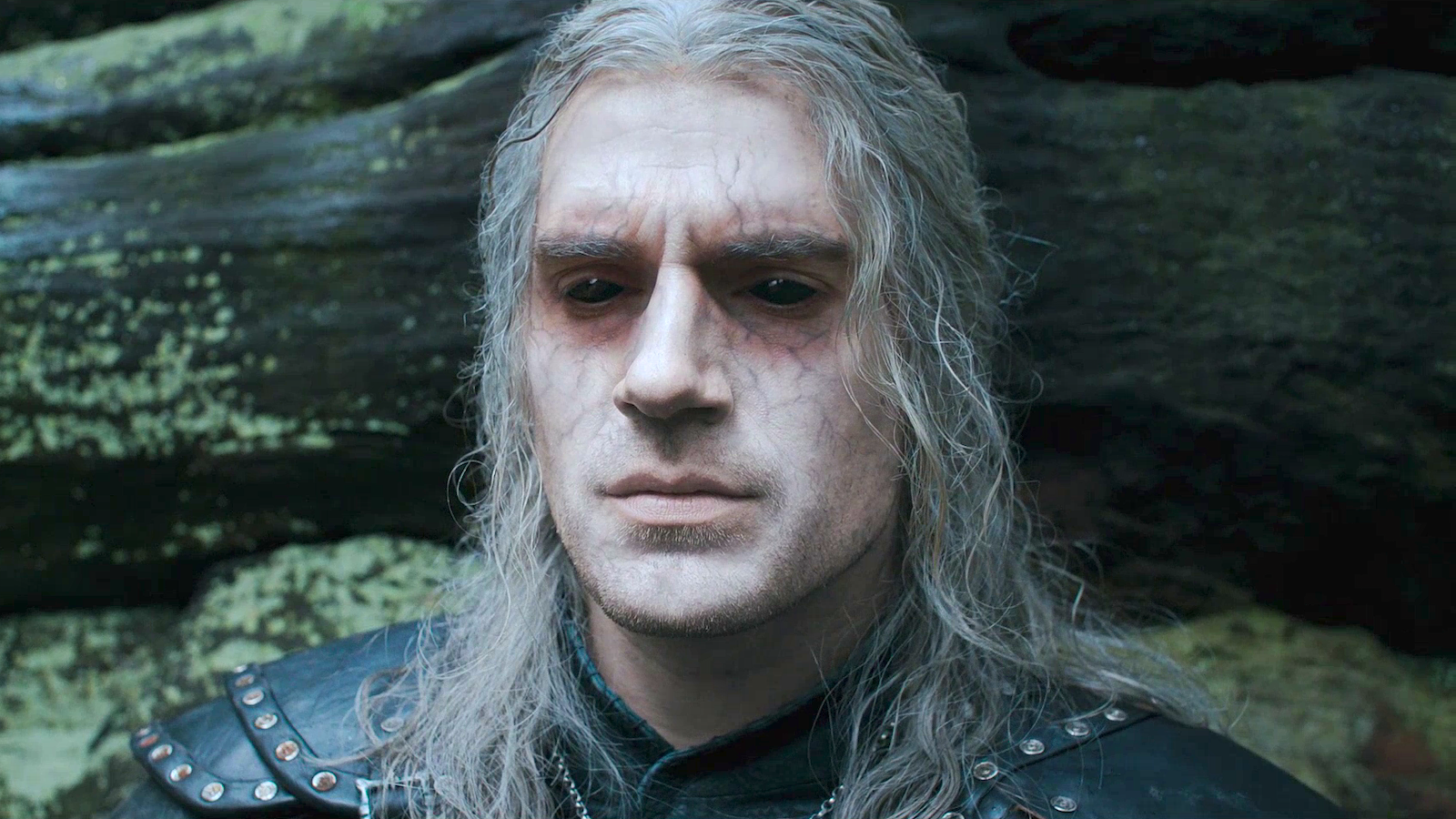 Geralt of Rivia (Henry Cavill) with dark veins surrounding his black eyes and white hair