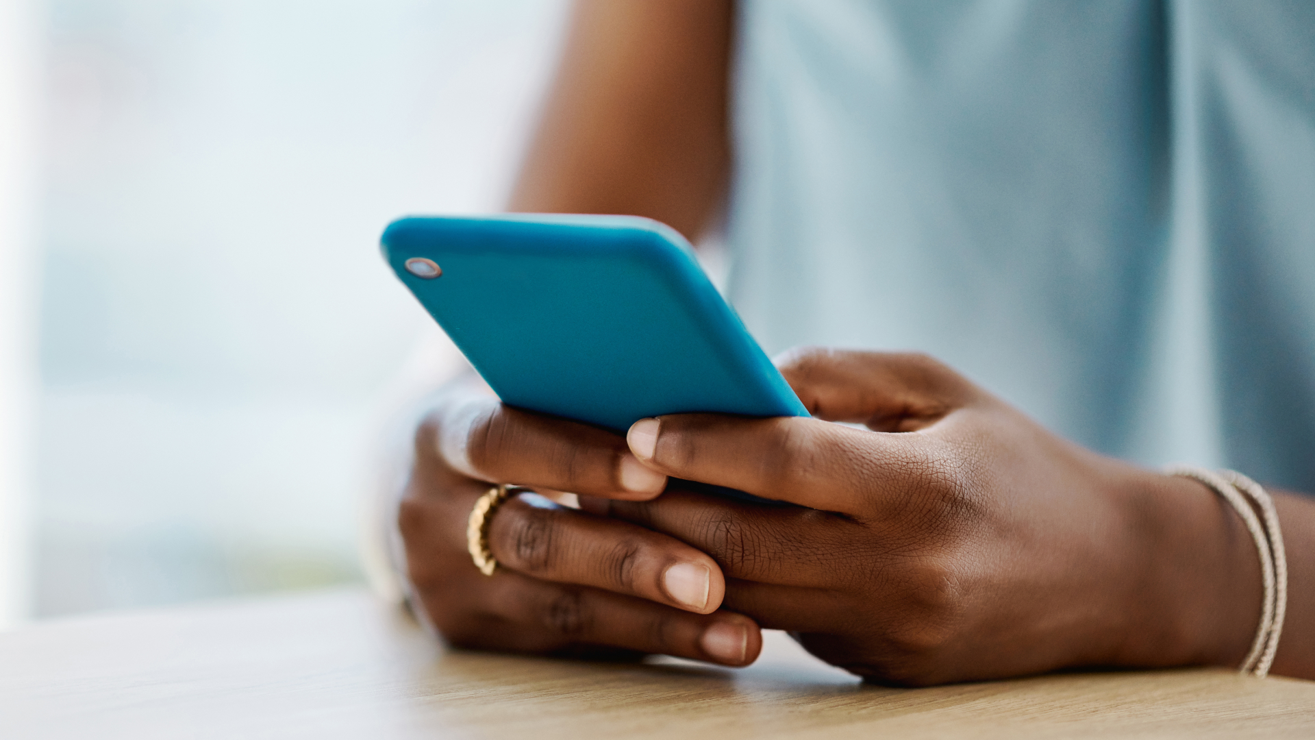 Hands holding phone - Getty