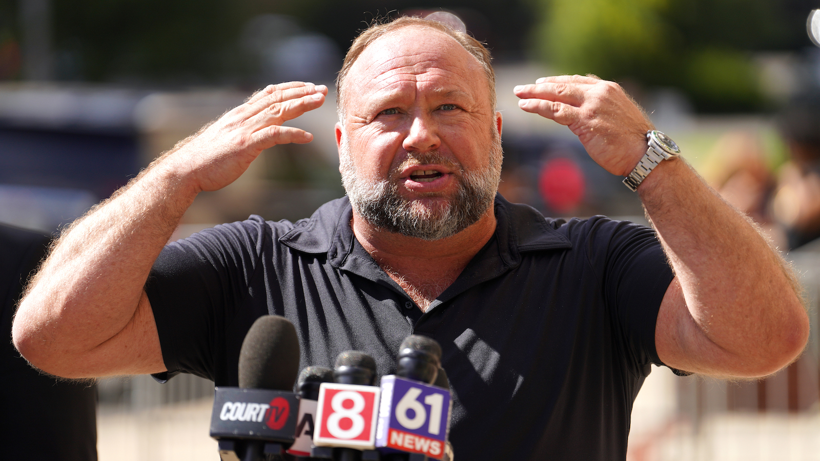 InfoWars founder Alex Jones speaks to the media outside Waterbury Superior Court during his trial on September 21, 2022 in Waterbury, Connecticut. Jones is being sued by several victims' families for causing emotional and psychological harm after they lost their children in the Sandy Hook massacre.