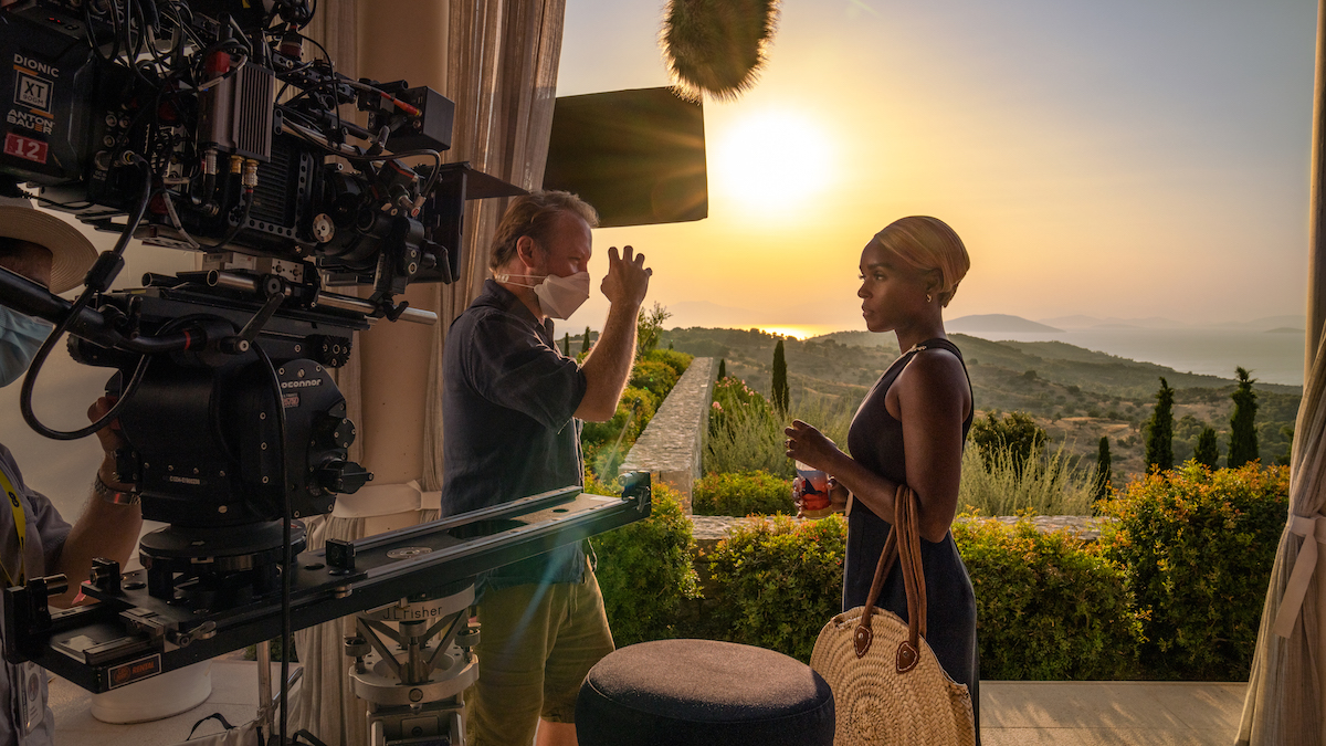 Behind the scenes shot of Janelle Monáe speaking with the director of 'Glass Onion: A Knives Out Mystery'