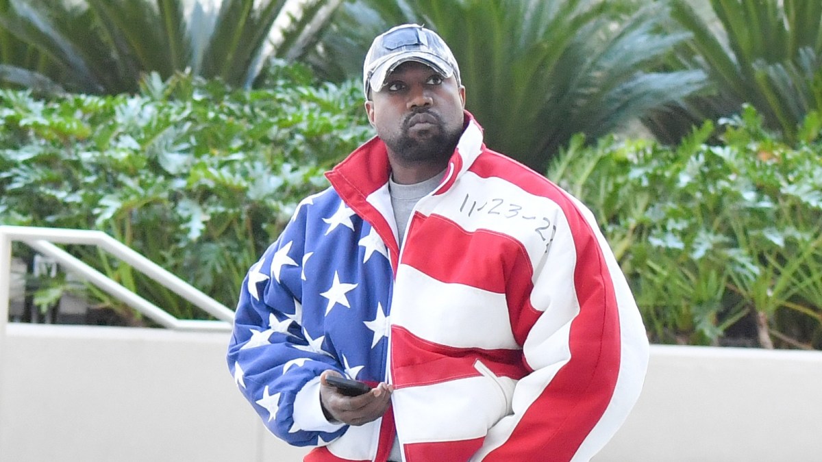 Kanye West is seen wearing an American flag jacket.