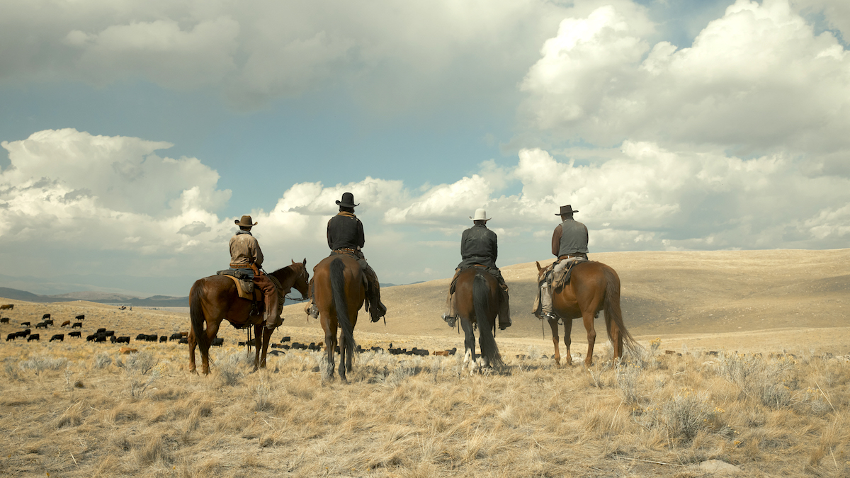 The cast of 1923 on horseback, looking out over the open plains