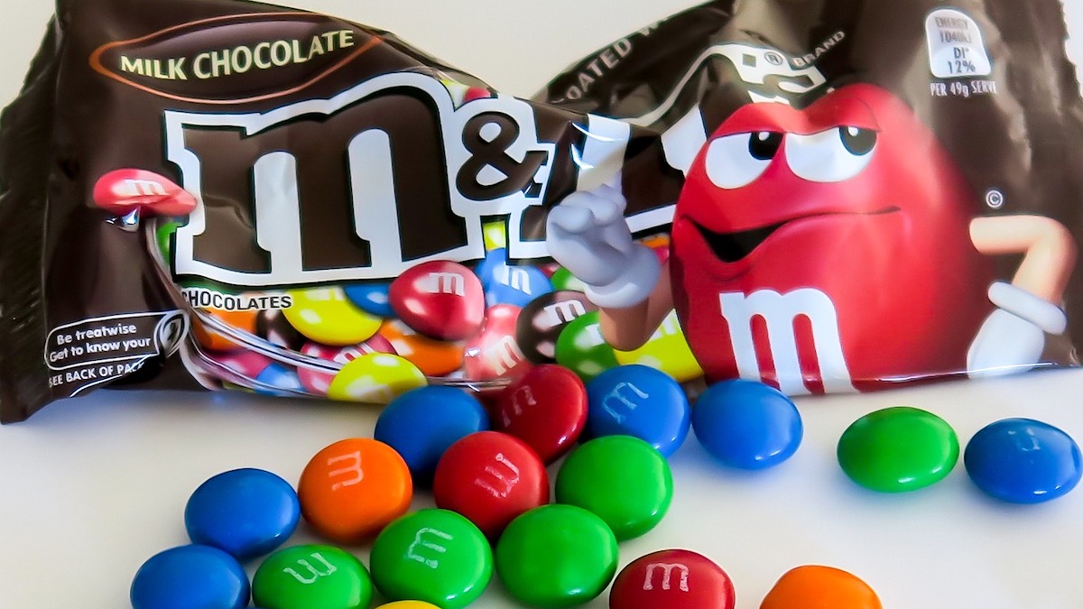 M&M's candy scattered around and M&M's bag