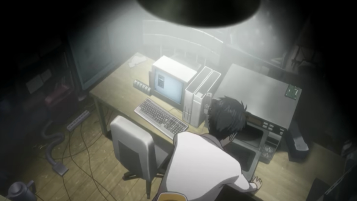 A man is sitting at his computer in Steins; Gate. 