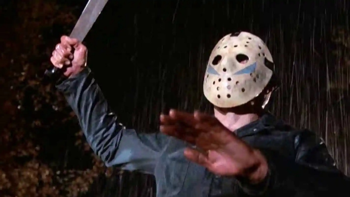 A character in Friday the 13th is wearing a hockey mask and holding up a knife. 