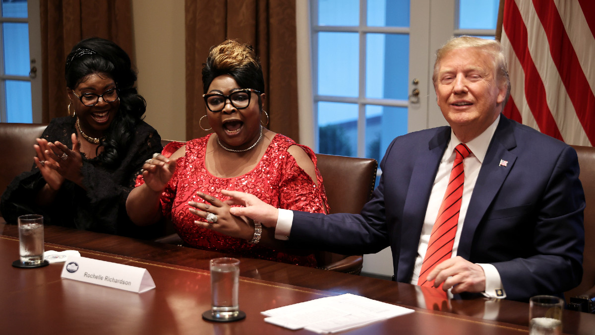 U.S. President Donald Trump (R) listens as Lynette 'Diamond' Hardaway (L) and Rochelle 'Silk' Richardson praise him during a news conference and meeting with African American supporters in the Cabinet Room at the White House February 27, 2020 in Washington, DC.