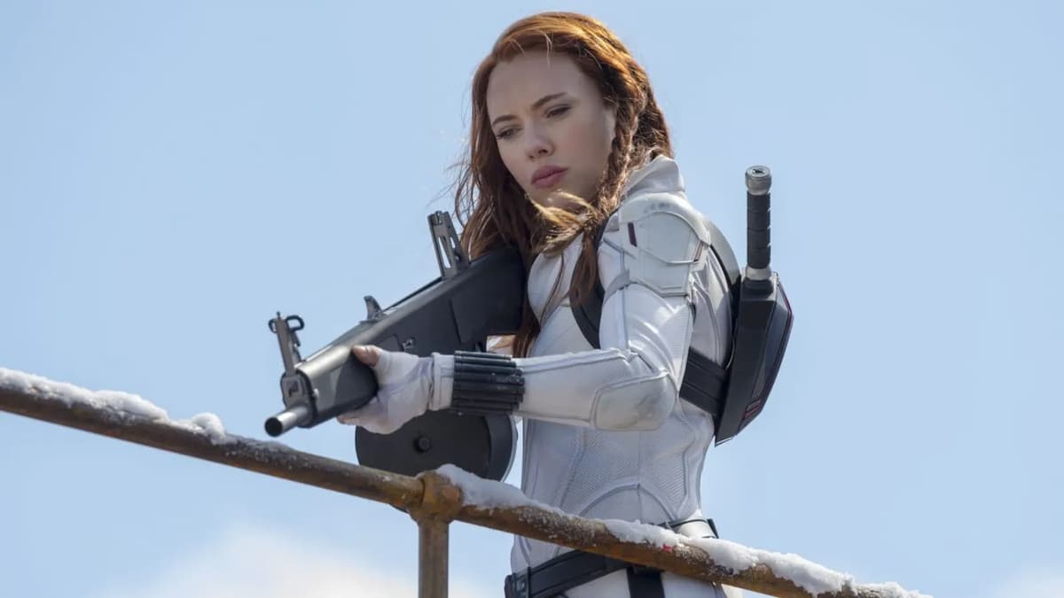 Scarlett Johansson's Natasha Romanoff wields a weapon while dressed in her White Widow suit in a photo from Black Widow.