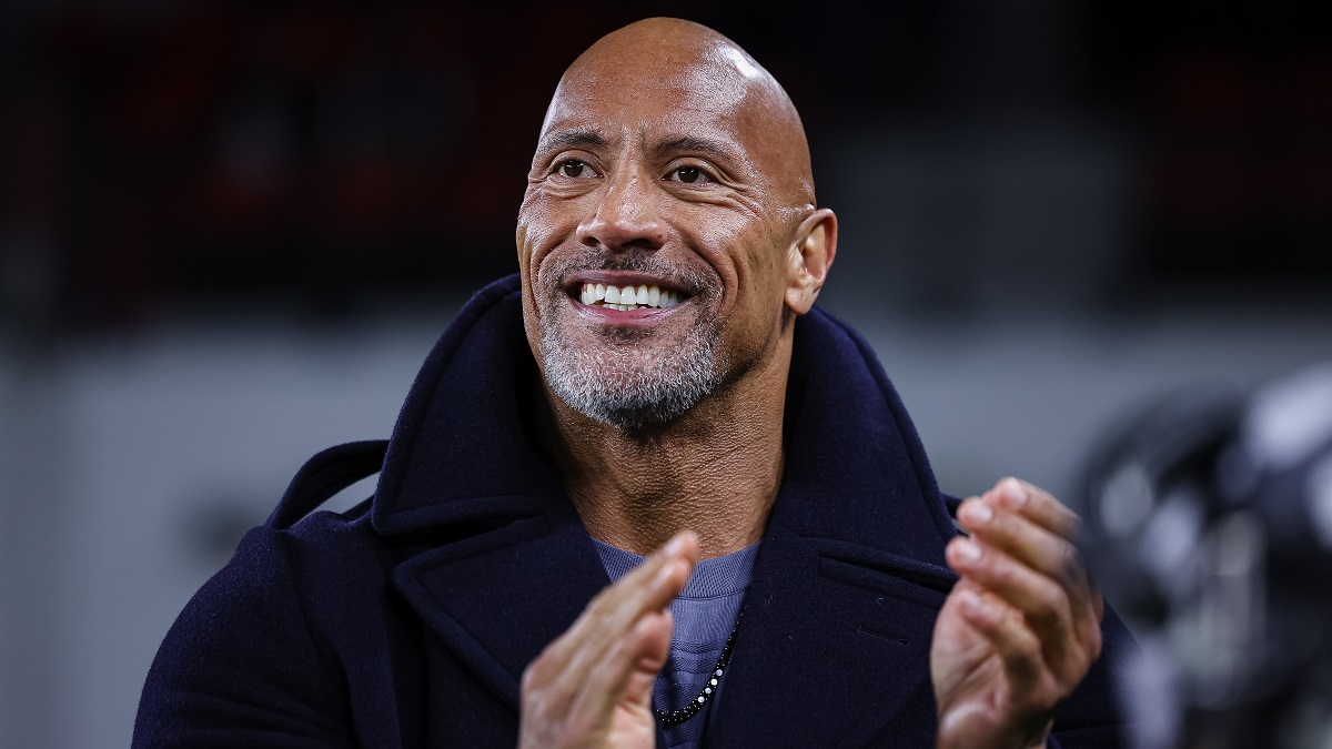 WASHINGTON, DC - FEBRUARY 19: (L-R) XFL owner Dwayne Johnson reacts on the sideline during the first half of the XFL game between the DC Defenders and the Seattle Sea Dragons at Audi Field on February 19, 2023 in Washington, DC.