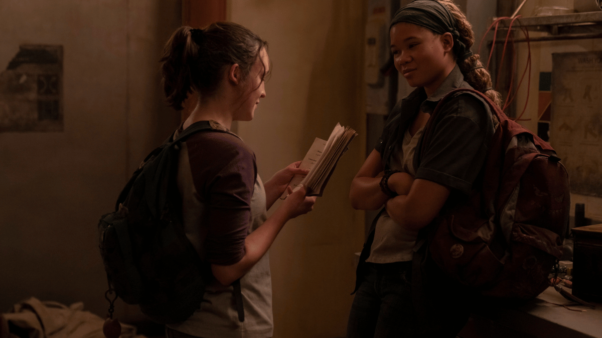 Riley (Storm Reid) and Ellie (Bella Ramsey) reading from a joke book