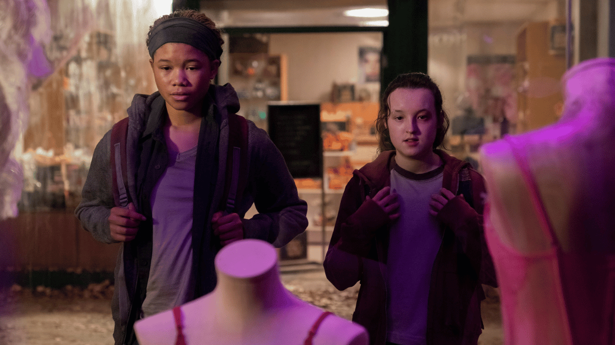 Riley (Storm Reid) and Ellie (Bella Ramsey) in a mall staring at a mannequin