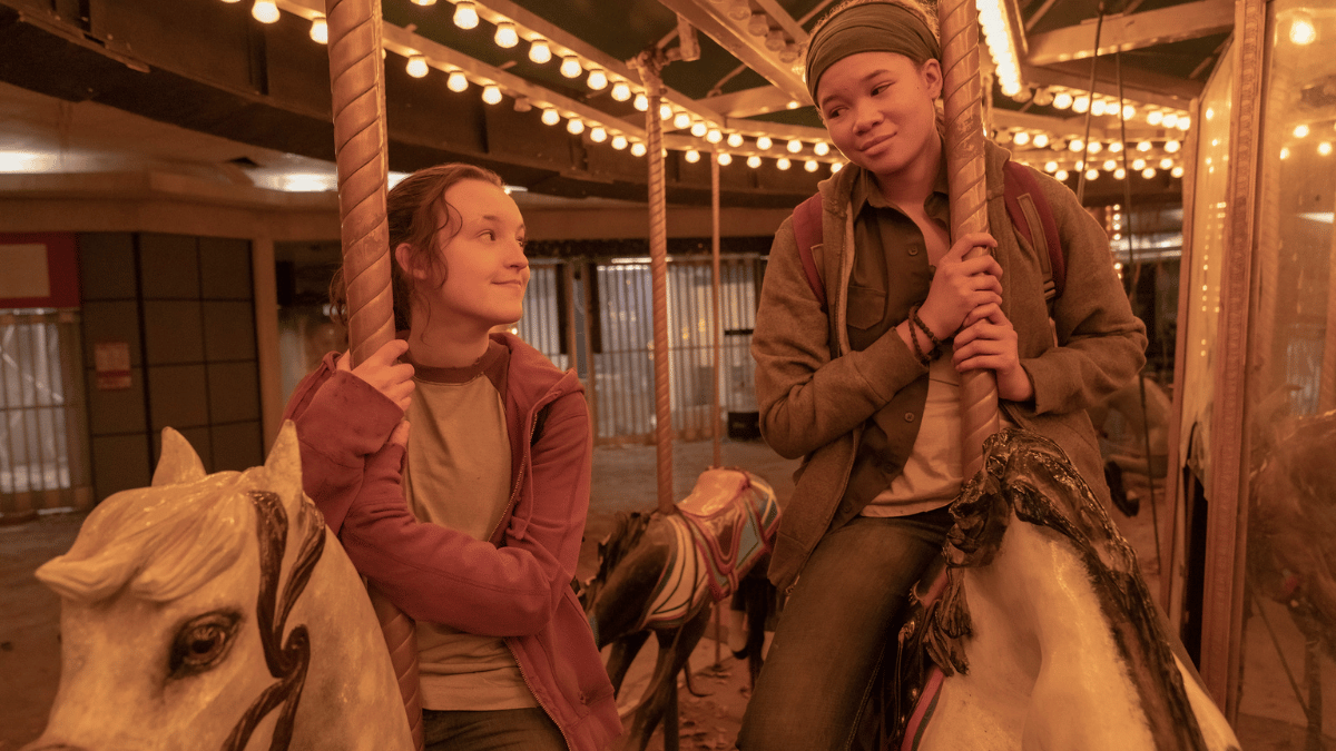 Riley (Storm Reid) and Ellie (Bella Ramsey) riding horses on a carousel