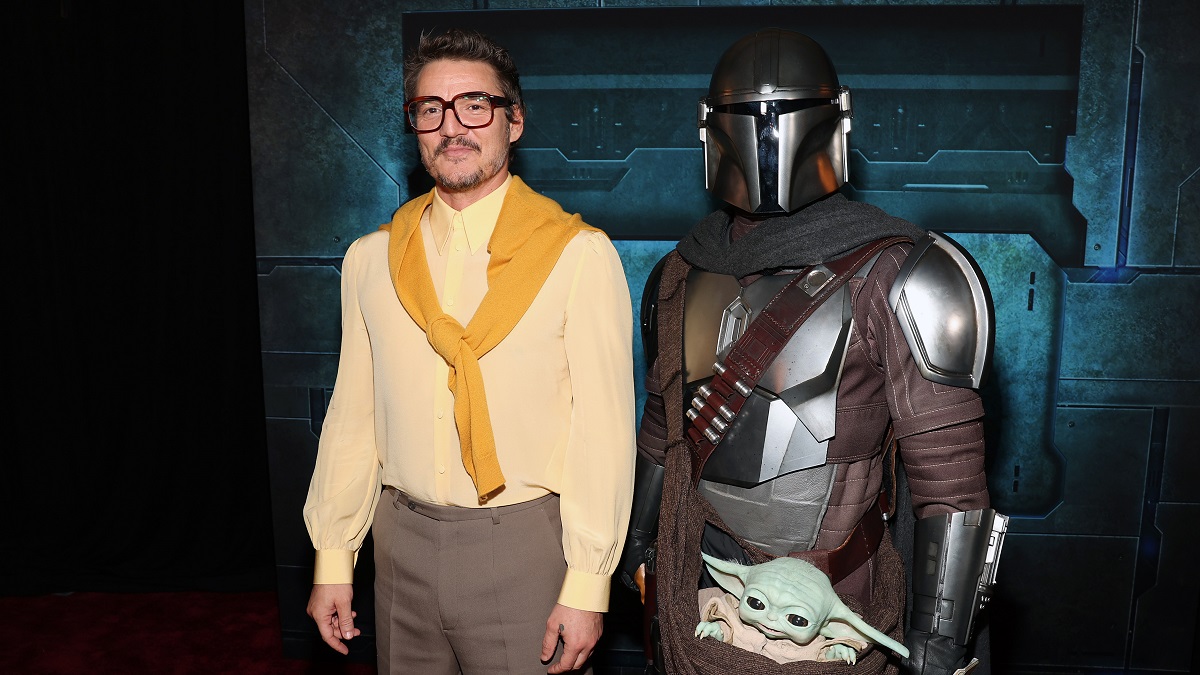 LOS ANGELES, CALIFORNIA - FEBRUARY 28: Pedro Pascal and a Disney Parks character attend the Mandalorian special launch event at El Capitan Theatre in Hollywood, California on February 28, 2023.