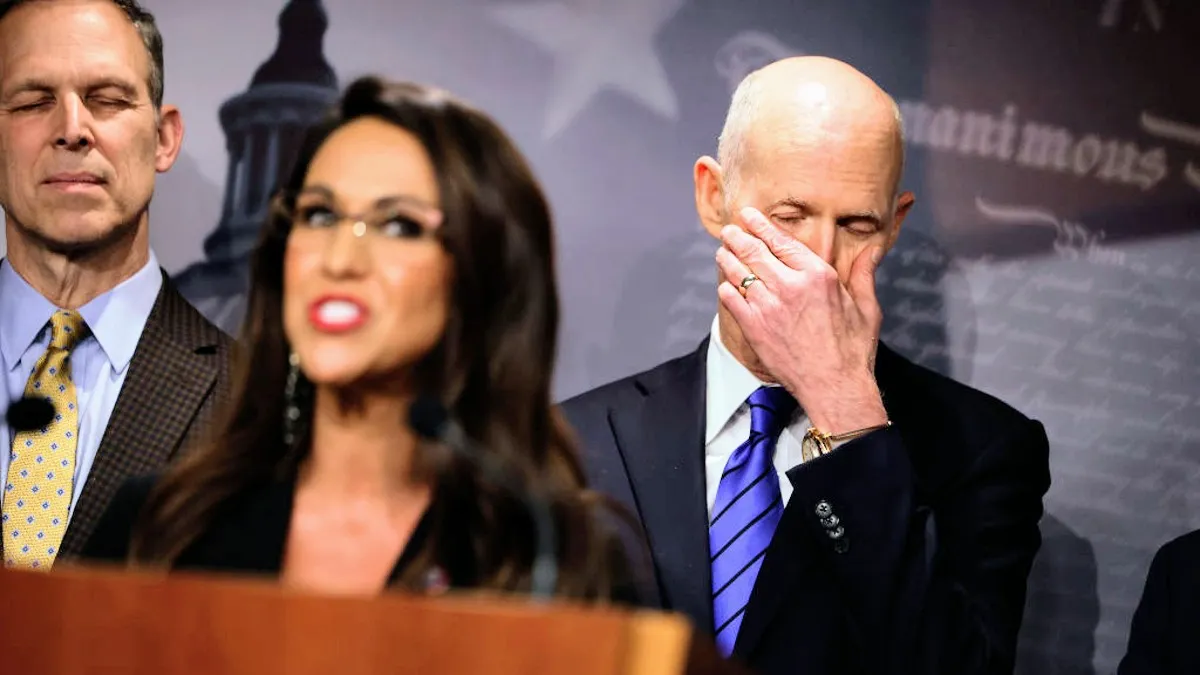 Sen. Sen. Rick Scott (R-FL) (R) listens to House Freedom Caucus member Rep. Lauren Boebert (R-CO) talk to reporters about the federal debt limit during a news conference caucus Chair Rep. Scott Perry (R-PA) (L) at the U.S. Capitol on March 22, 2023 in Washington, DC
