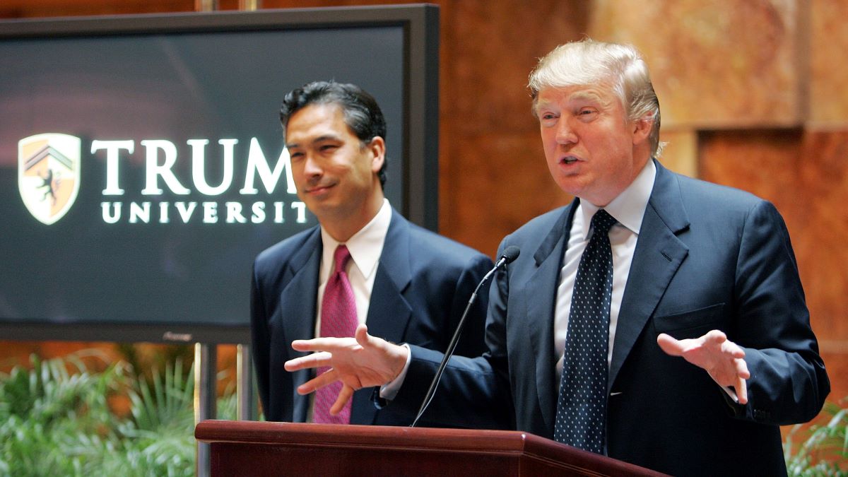  Real estate mogul Donald Trump (R) speaks as university president Michael Sexton (L) looks on during a news conference announcing the establishment of Trump University May 23, 2005 in New York City. Trump University will consist of on-line courses, CD-ROMS and other learning programs for business professionals. (Photo by Mario Tama/Getty Images)