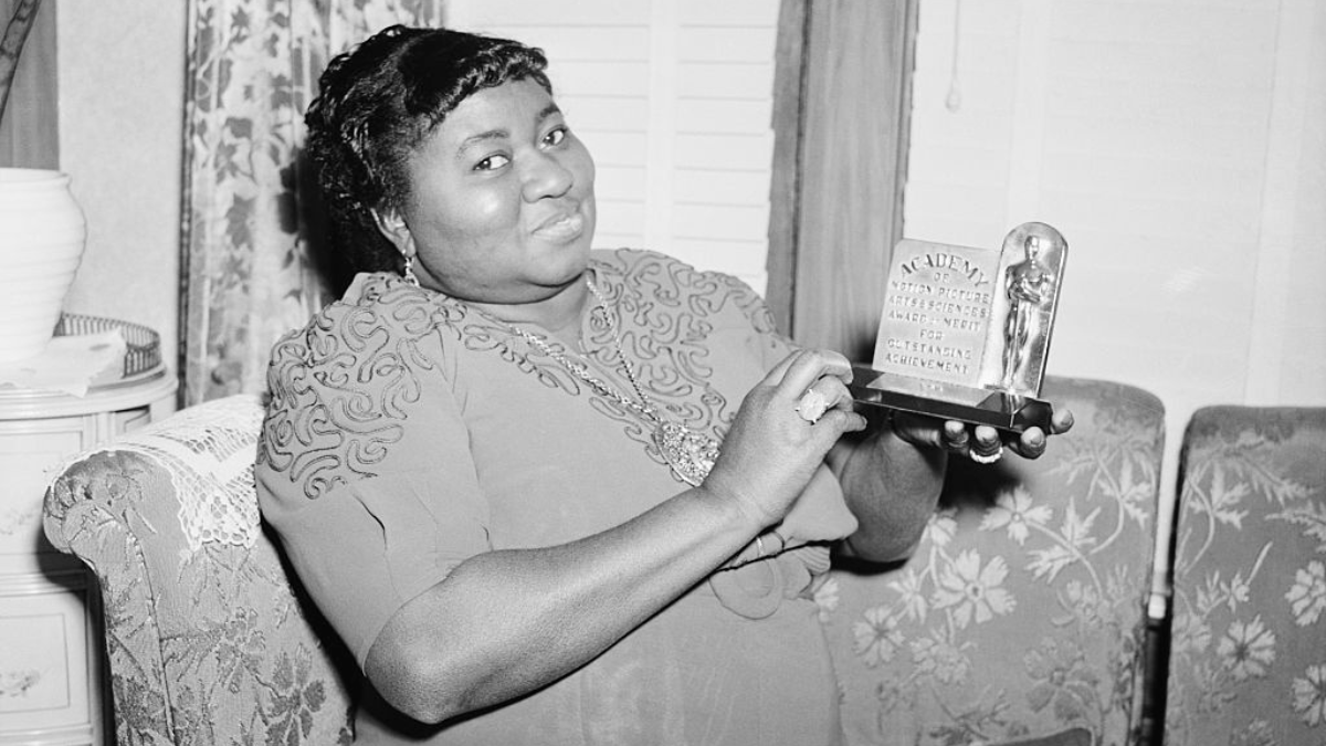 Los Angeles, CA: Actress Hattie Mc Daniel is shown with the statuette she received for her portrayal in "Gone With The Wind." The award was for Best Supporting Role by an Actress, and was made at the 12th annual Academy Awards ceremony.