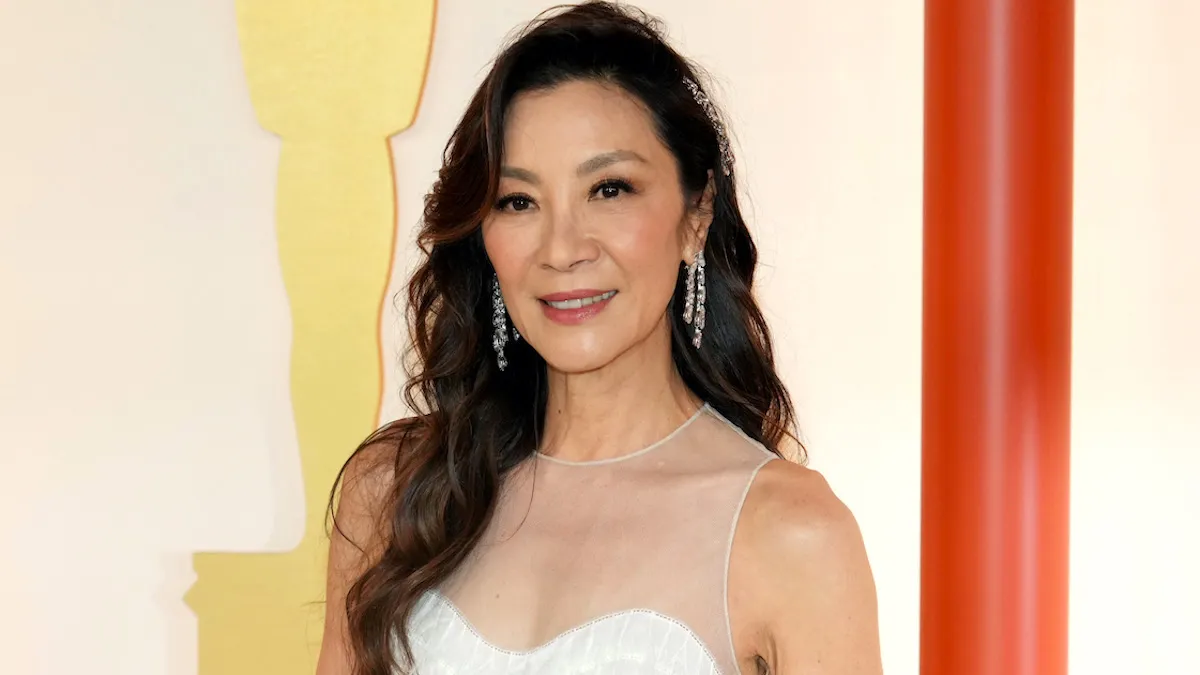Michelle Yeoh dressed in white on the champagne carpet at the 95th Annual Academy Awards