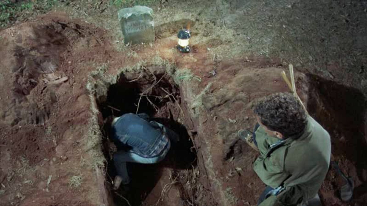 A character is standing inside a dug grave in Friday the 13th. 
