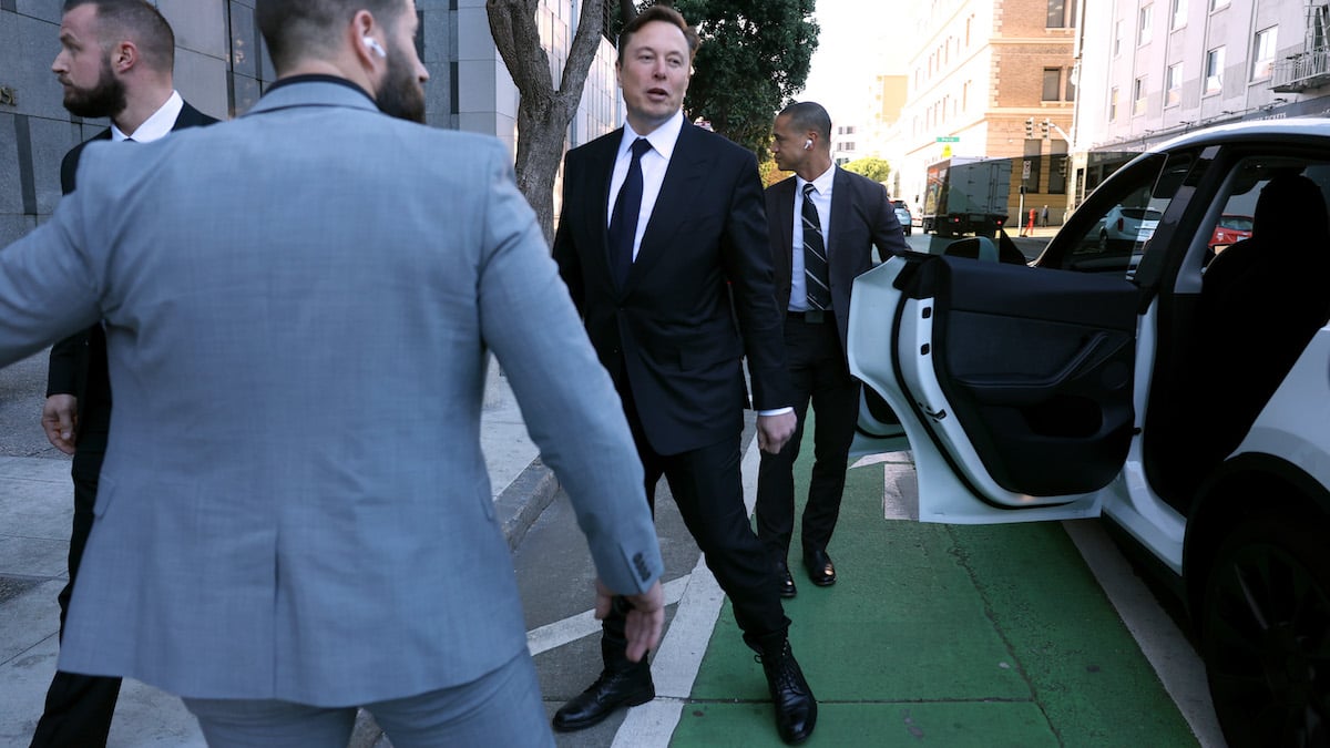 Elon Musk getting out of a car