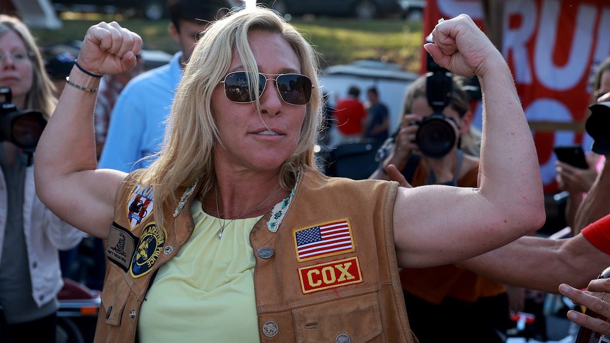 PLAINVILLE, GEORGIA - MAY 20: Rep. Marjorie Taylor Greene (R-GA) flexes her muscles during a Bikers for Trump campaign event held at the Crazy Acres Bar & Grill on May 20, 2022 in Plainville, Georgia. Rep. Greene is running for a second congressional term in the state's upcoming midterm primary.