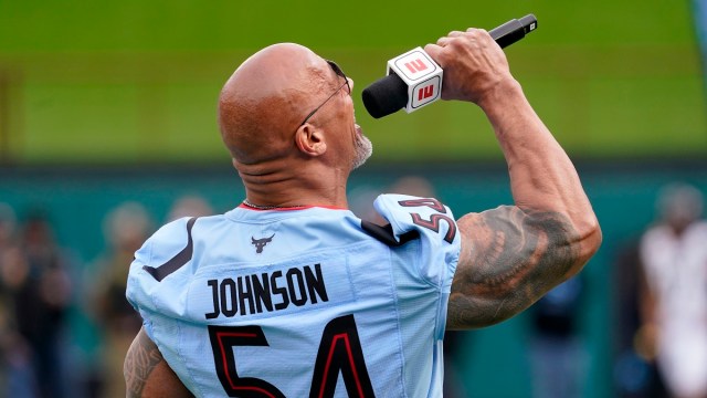 ARLINGTON, TEXAS - FEBRUARY 18: XFL owner Dwayne Johnson talks on the field before the game between the Arlington Renegades and the Vegas Vipers at Choctaw Stadium on February 18, 2023 in Arlington, Texas.