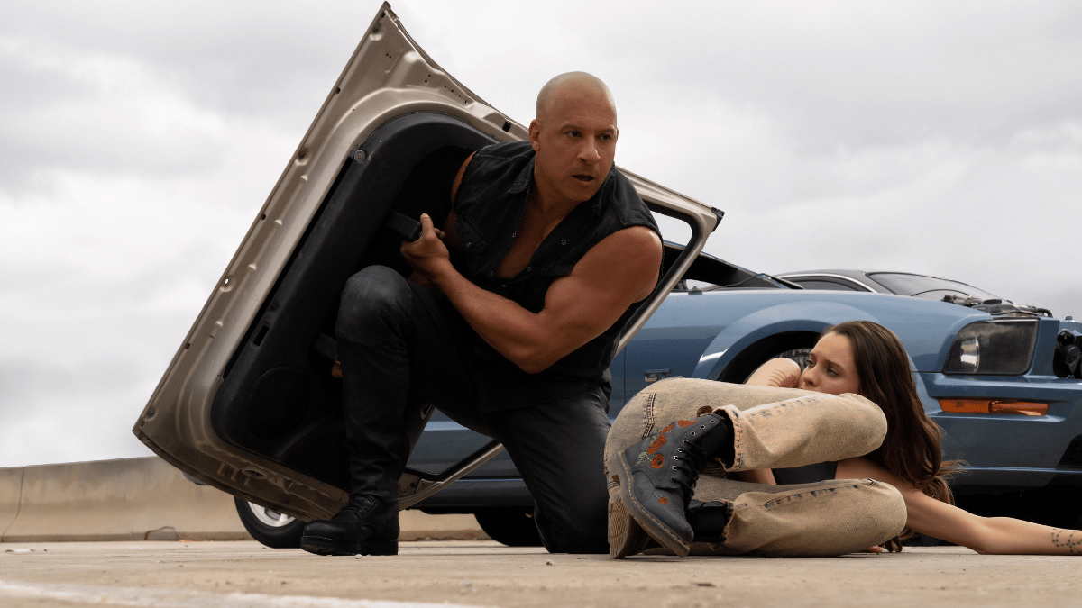 Dom (Vin Diesel) uses a car door as cover