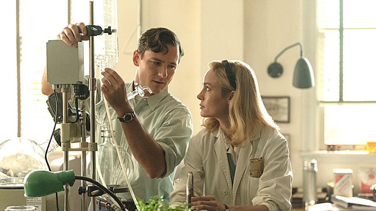 Elizabeth and Calvin are looking at each other in a lab in Lessons in Chemistry.