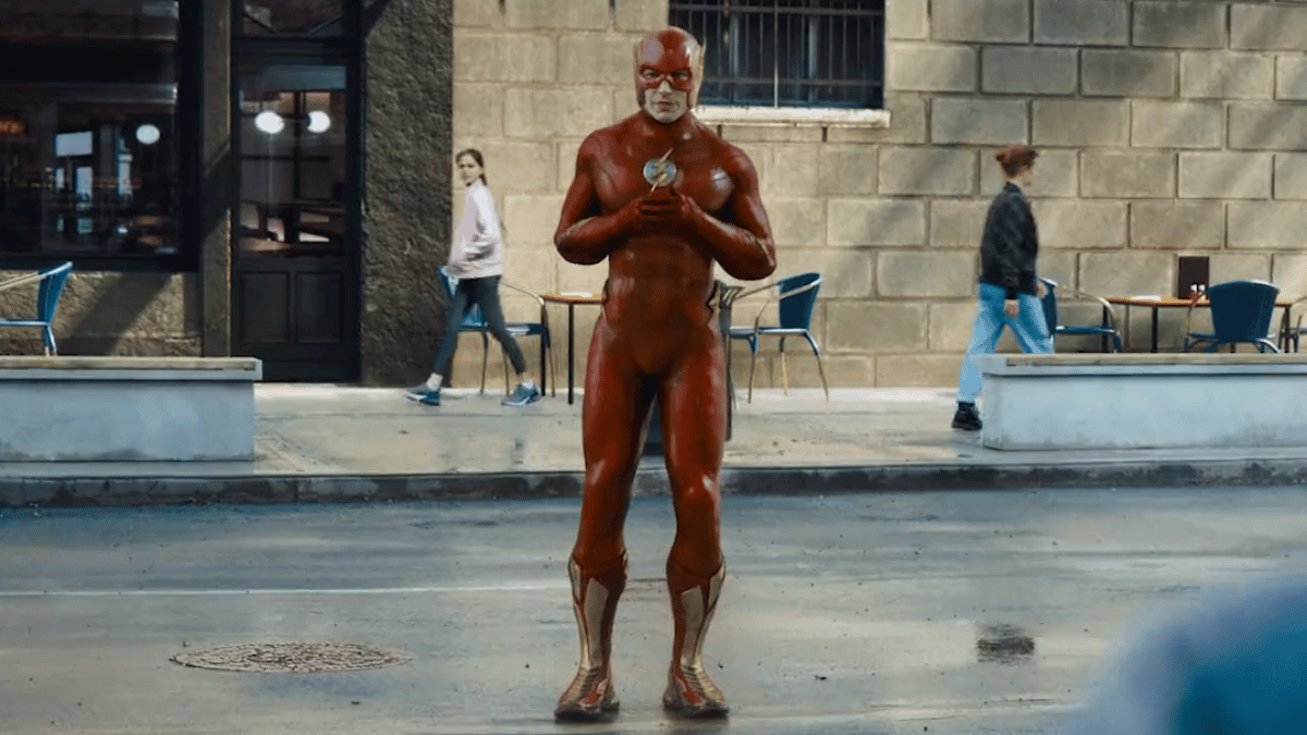 The Flash (Ezra Miller) awkwardly stands in the middle of a street
