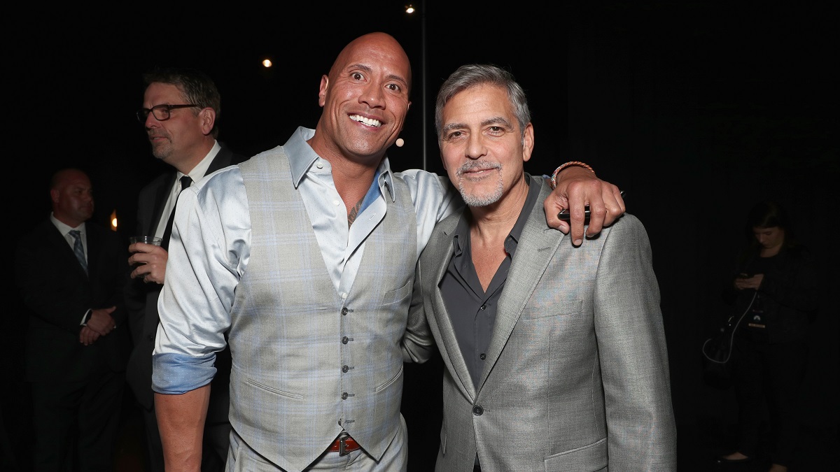 LAS VEGAS, NV - MARCH 28: Actors Dwayne Johnson (L) and George Clooney at CinemaCon 2017 Paramount Pictures Presentation Highlighting Its Summer of 2017 and Beyond at The Colosseum at Caesars Palace during CinemaCon, the official convention of the National Association of Theatre Owners, on March 28, 2017 in Las Vegas, Nevada.