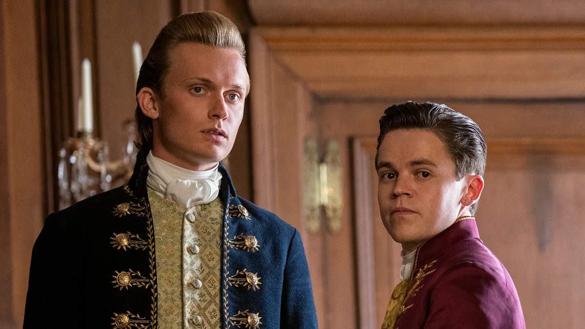 Freddie Dennis as Reynolds and Sam Clemmett as young Brimsley in 'Queen Charlotte: A Bridgerton Story'