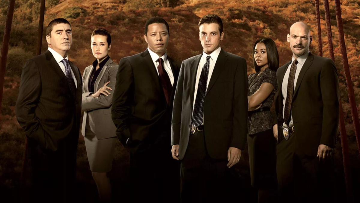 Characters from Law and Order LA are posing in front of trees.