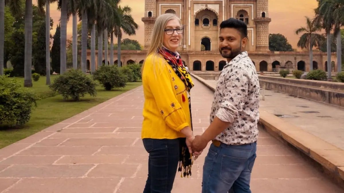Jenny and Sumit hold hands in India.