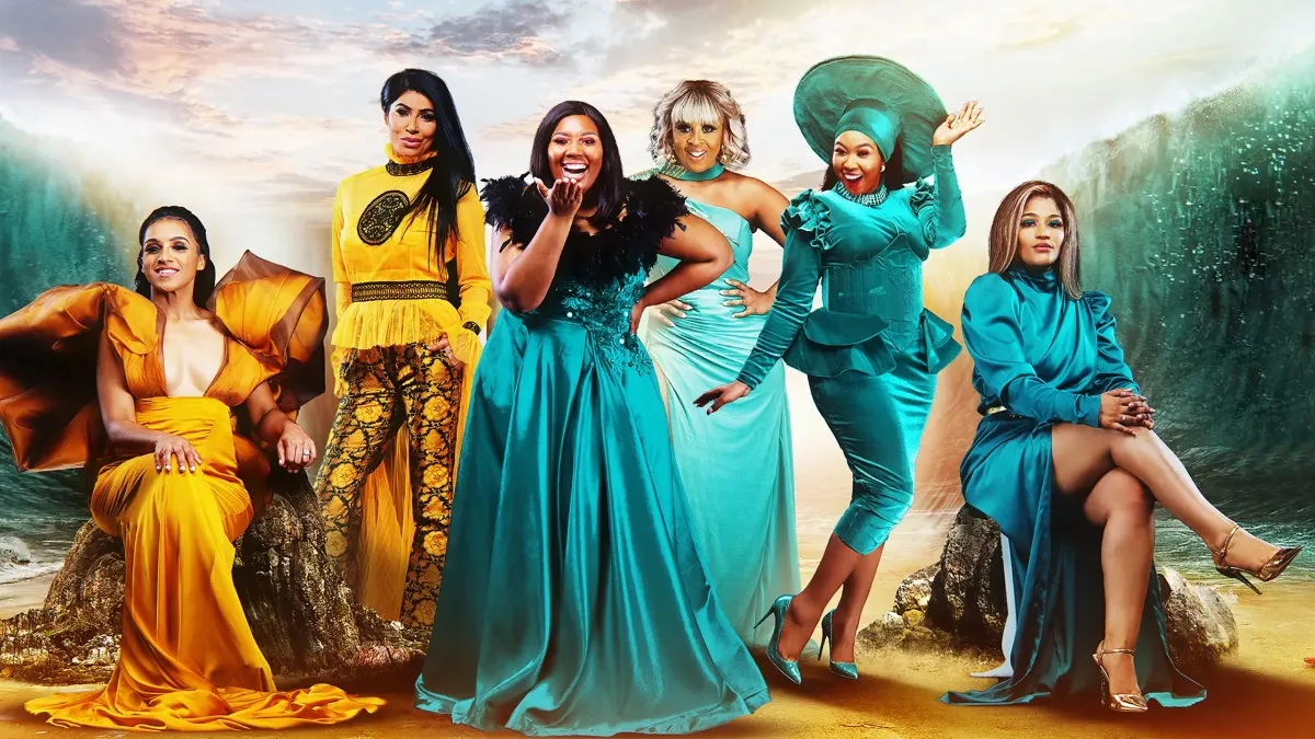 The cast of The Real Housewives of Nairobi dressed in blue by the ocean.
