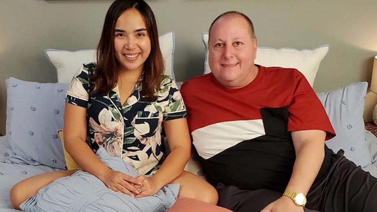 David and Annie Tobolowsky smiling in bed together