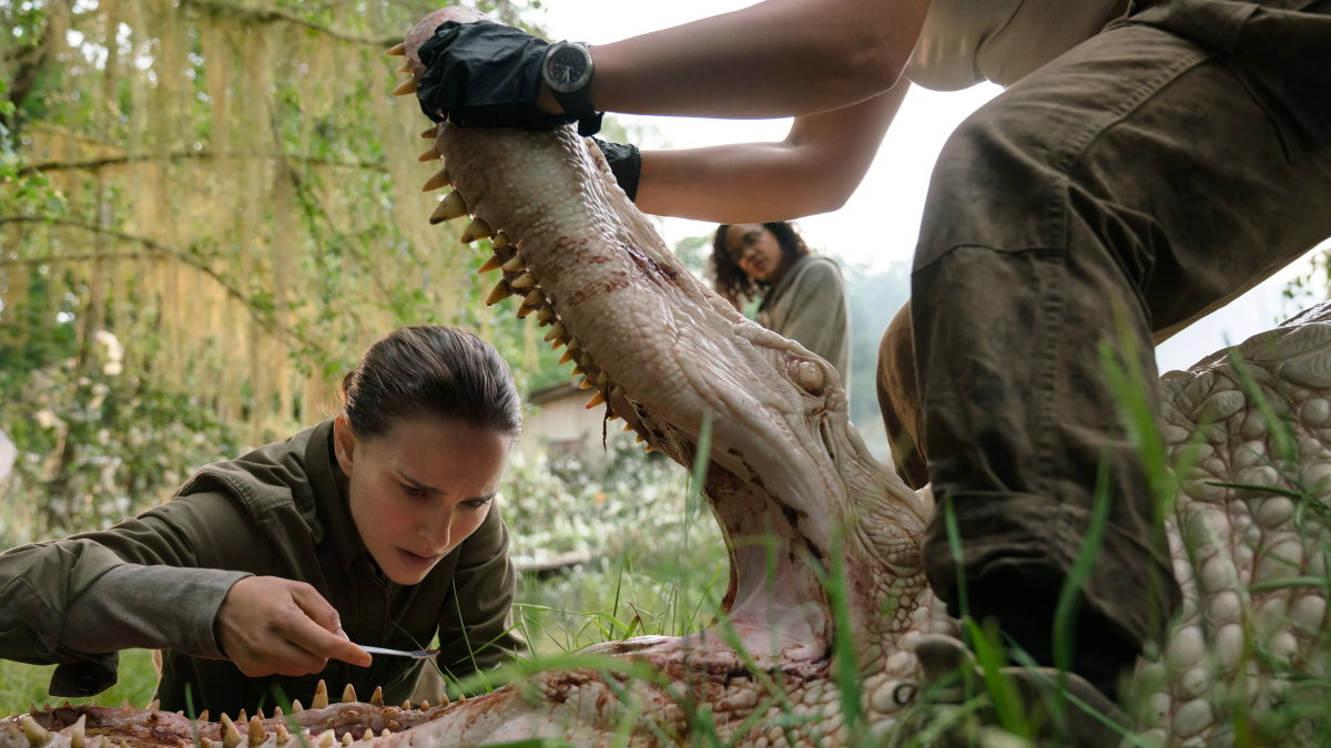 Natalie Portman feeding an alligator some soup.