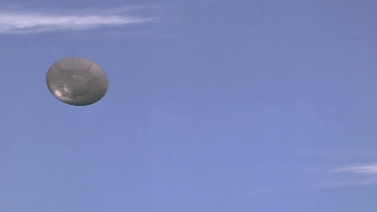 A flying saucer against a blue sky
