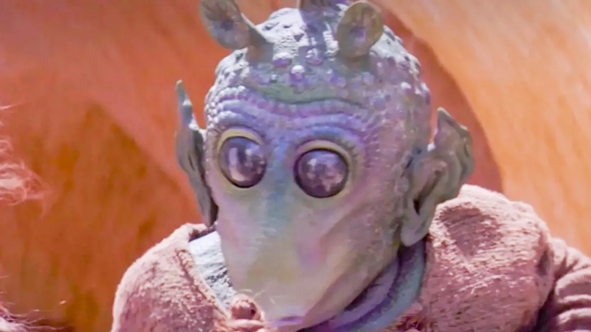 Greedo from Star Wars is looking straight ahead.